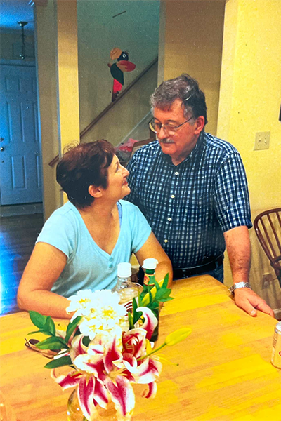 Elderly couple at kitchen table aging in place with dignity